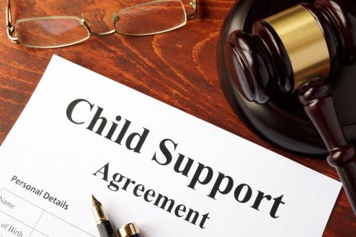 Child support agreement on an office table. Modify Child Support concept
