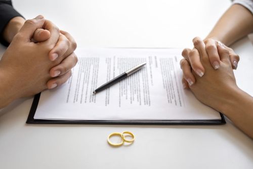 Divorce agreement and wedding rings. Alimony After Remarriage concept.